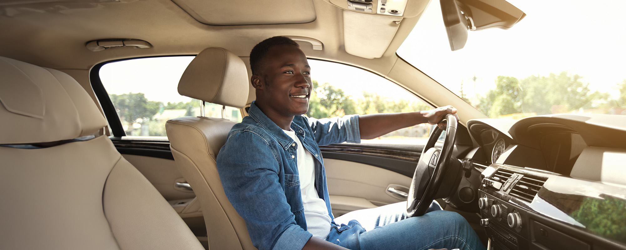 happy black guy driving car