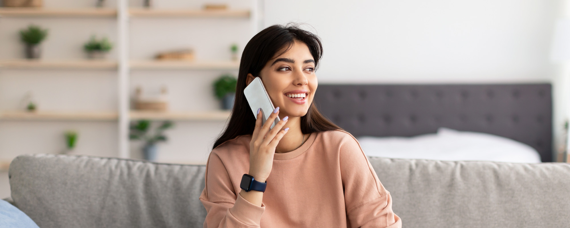 portrait of smiling woman talking on phone
