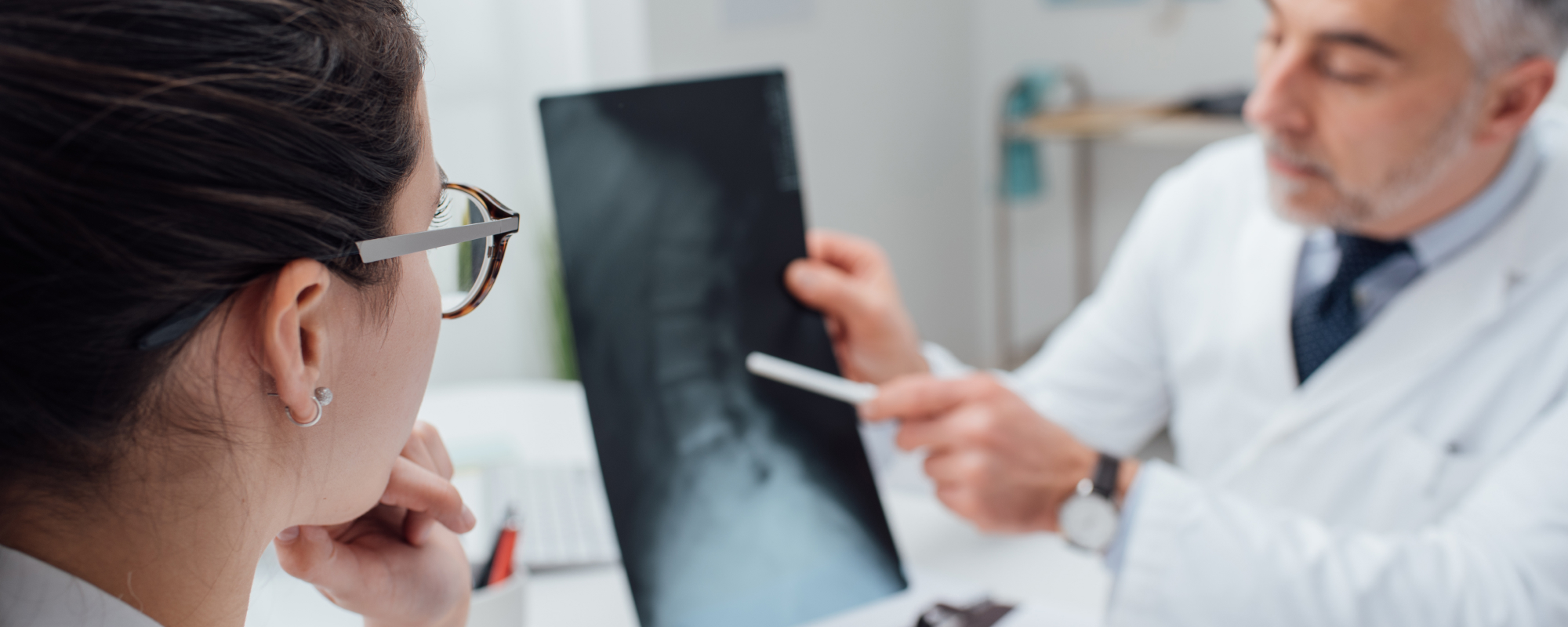 Doctor showing patient a spinal injury on their xray - Rockland County Spinal Injury Lawyers concept image