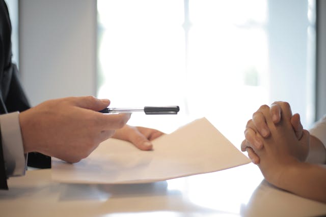 two people about to sign a contract