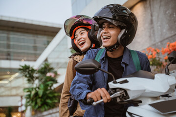 couple on motorcycle wearing helmet