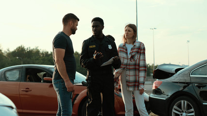 police officer with man and woman after car accident