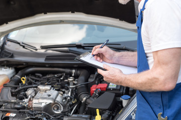 mechanic looking at car