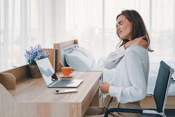 woman with neck pain at desk