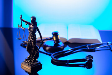 lady justice with gavel, book, and stethoscope