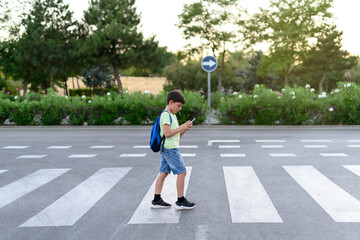 kid walking while distracted by phone