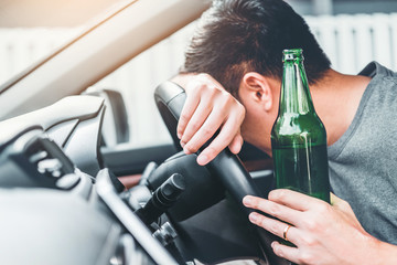 drunk driver holding beer bottle