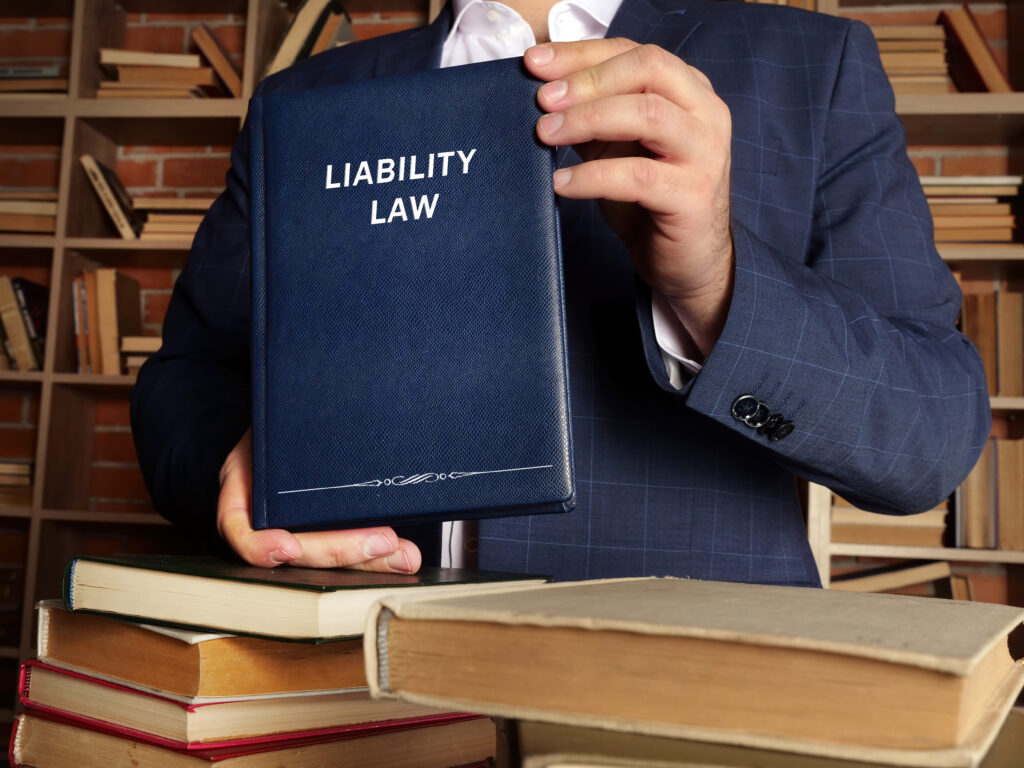 person holding legal book that says liability law